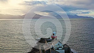 Aerial panorama view of the historic Fenit Lighthouse in Tralee Bay, beautiful clouds, sunset