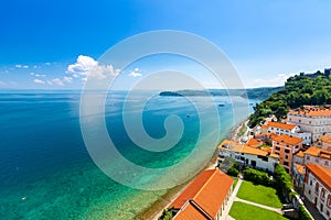 Aerial panorama view of Piran city, Slovenia. Look from tower in church. In foreground are small houses, Adriatic sea in