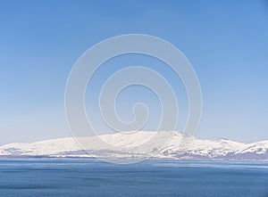 Aerial panorama view snow covered mountains. Snowy mountain ridge on winter sunrise. Stunning mountains range covered with snow