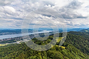 Aerial panorama view of Zurich cityscape skyline and Zurich lake from top of Uetliberg mountain on a cloudy summer day with