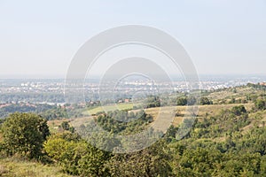 Aerial panoramal of Novi Sad, seen from a hill of Fruska Gora National park during a summer afternoon.