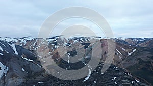 Aerial panoramic descending footage of mountain landscape. Ridges covered with snow. Thorsmork valley, Iceland