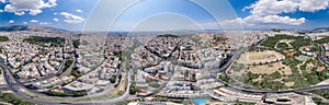 Aerial panoramic drone shot of Athens center with Oplymion Site, Lycabettus hill, acropolis