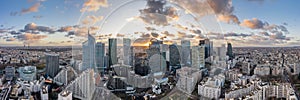 Aerial panoramic drone shot of La Defense skycraper in Paris CBD skyscraper complex with clouds during sunset photo