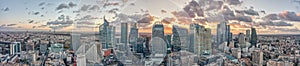 Aerial panoramic drone shot of La Defense skycraper in Paris CBD skyscraper complex with clouds during sunset photo