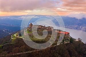Aerial panoramic drone view of the beautiful high castle of Visegrad on a moody winter morning