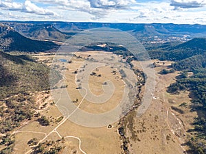 Aerial panoramic drone view of Wolgan Valley along the Wolgan River in the Lithgow Region of New South Wales, Australia.