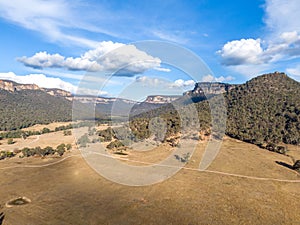 Aerial panoramic drone view of Wolgan Valley along the Wolgan River in the Lithgow Region of New South Wales, Australia.