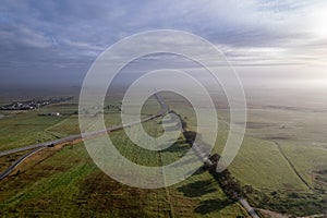 Aerial panoramic foggy sunrise view of Alentejo countryside farmlands, shot near Castro Verde village in Alentejo region, a