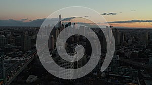 Aerial panoramic footage of Downtown Brooklyn at dusk. Busy roads leading from bridges and high rise office of apartment