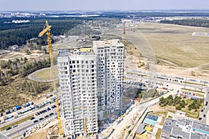 Aerial panoramic image of construction site with multistory apartment buildings and cranes