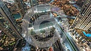 Aerial panoramic look down view of a big futuristic city night timelapse. Business bay and Downtown