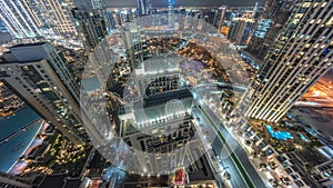 Aerial panoramic look down view of a big futuristic city night timelapse. Business bay and Downtown