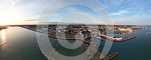 Aerial panoramic shot of a port with Southampton's buildings in the background, England