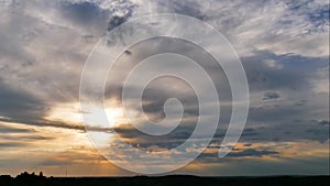 Aerial panoramic time lapse of epic sunset into the flying blue clouds over horizon in the twilight sky.  View from the top of the