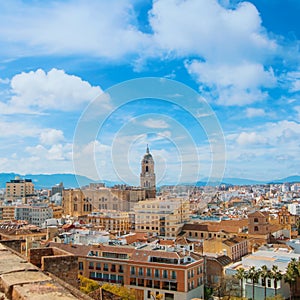 Aerial panoramic top view over the roofs to a tower of Malaga Ca