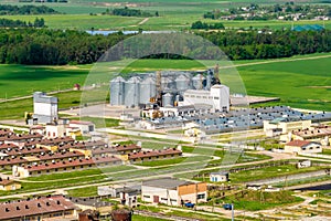aerial panoramic view on agro-industrial complex with silos and grain drying line for drying cleaning and storage of cereal crops