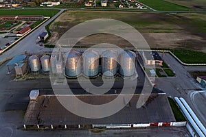 aerial panoramic view on agro-industrial complex with silos and grain drying line for drying cleaning and storage of cereal crops