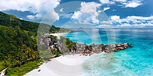 Aerial panoramic view of beautiful Grand Anse beach on La Digue island in Seychelles. Granite boulders ridge and