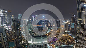 Aerial panoramic view of a big futuristic city all night timelapse. Business bay and Downtown