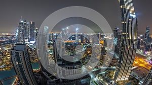 Aerial panoramic view of a big futuristic city all night timelapse. Business bay and Downtown