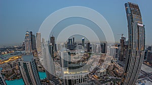 Aerial panoramic view of a big futuristic city day to night timelapse. Business bay and Downtown