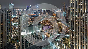 Aerial panoramic view of a big futuristic city night timelapse. Business bay and Downtown