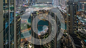 Aerial panoramic view of a big futuristic city night timelapse. Business bay and Downtown