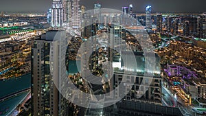 Aerial panoramic view of a big futuristic city night timelapse. Business bay and Downtown