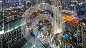 Aerial panoramic view of a big futuristic city night timelapse. Business bay and Downtown