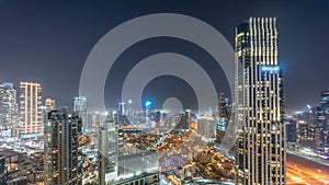 Aerial panoramic view of a big futuristic city night timelapse. Business bay and Downtown