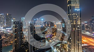 Aerial panoramic view of a big futuristic city night timelapse. Business bay and Downtown