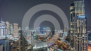 Aerial panoramic view of a big futuristic city night timelapse. Business bay and Downtown