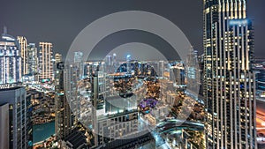 Aerial panoramic view of a big futuristic city night timelapse. Business bay and Downtown