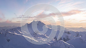 Aerial Panoramic View of Canadian Mountain covered in snow.