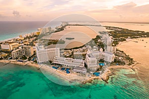 Aerial panoramic view of Cancun beach and city hotel zone in Mexico at sunset. Caribbean coast landscape of Mexican