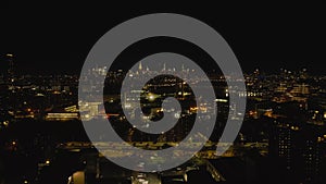 Aerial panoramic view of cityscape at night. Busy trunk road, illuminated buildings and Manhattan skyscrapers in