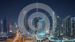 Aerial panoramic view of Dubai Downtown skyline with many towers all night timelapse.