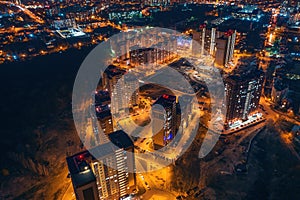 Aerial panoramic view, flight on drone above night city Voronezh with illuminated roads and high-rise buildings