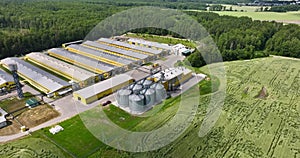 Aerial panoramic view and flight over silos and agro-industrial livestock complex on agro-processing and manufacturing plant with