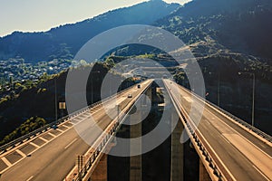 Aerial panoramic view on the highway bridge over the deep gorge