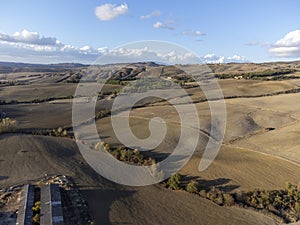 Aerial panoramic view on hills near Pienza, Tuscany, Italy. Tuscan landscape with cypress trees, vineyards, forests and ploughed