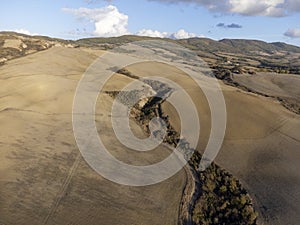 Aerial panoramic view on hills near Pienza, Tuscany, Italy. Tuscan landscape with cypress trees, vineyards, forests and ploughed