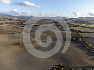 Aerial panoramic view on hills near Pienza, Tuscany, Italy. Tuscan landscape with cypress trees, vineyards, forests and ploughed