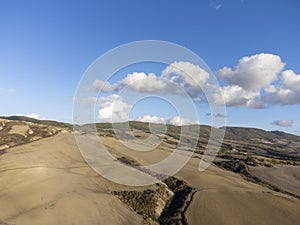 Aerial panoramic view on hills near Pienza, Tuscany, Italy. Tuscan landscape with cypress trees, vineyards, forests and ploughed