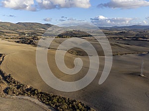 Aerial panoramic view on hills of Val d`Orcia near Pienza, Tuscany, Italy. Tuscan landscape with cypress trees, vineyards, forest