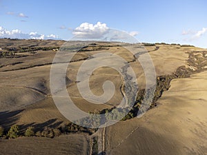 Aerial panoramic view on hills of Val d`Orcia near Pienza, Tuscany, Italy. Tuscan landscape with cypress trees, vineyards, forest