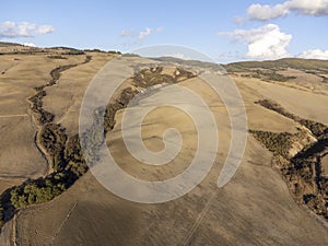 Aerial panoramic view on hills of Val d`Orcia near Pienza, Tuscany, Italy. Tuscan landscape with cypress trees, vineyards, forest