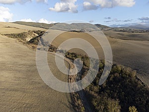 Aerial panoramic view on hills of Val d`Orcia near Pienza, Tuscany, Italy. Tuscan landscape with cypress trees, vineyards, forest