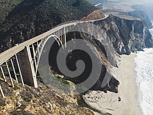 Aerial panoramic view of historic Bixby Creek Bridge along world famous Pacific Coast Highway 1 in summer sunny day , Monterey